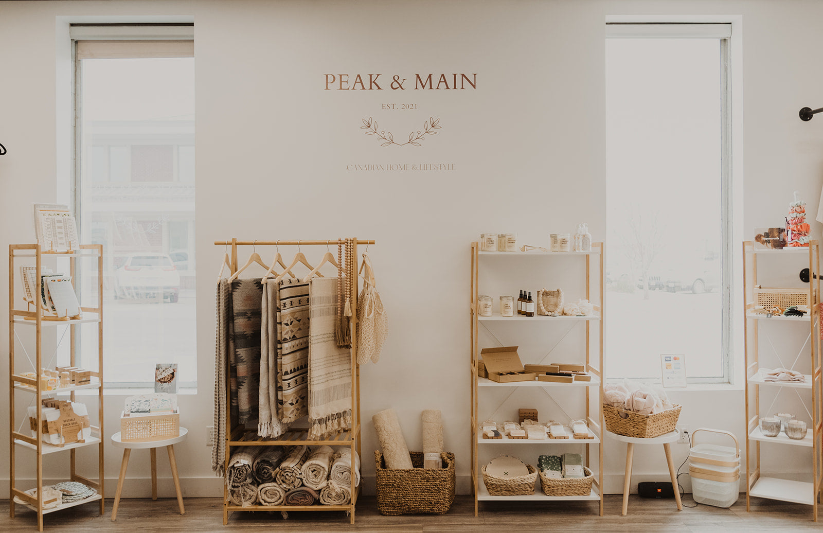 peak and main store display showcasing blankets and accessories on shelving against a white wall